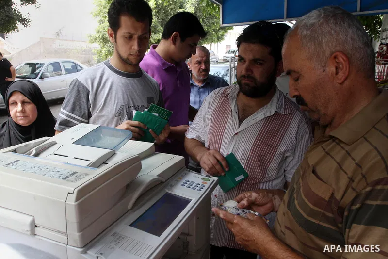 Palestinians photocopy their papers and passports to register for travel throw the Beit Hanoun crossing (Erez) in front of the Ministry of Civil affairs' office, in Gaza City Aug 21, 2013. Israel and the Palestinians hav...