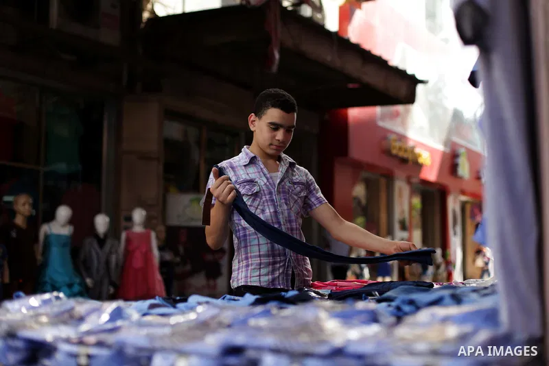 Palestinians shop during preperation for the new school year at a market in Gaza City on Aug 21, 2013. Palestinian Ministry of Education announced the 25 August is the first day of new school year in the West Bank and Ga...