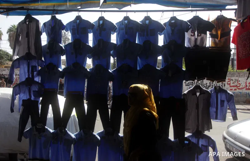 Palestinians shop during preperation for the new school year at a market in Gaza City on Aug 21, 2013. Palestinian Ministry of Education announced the 25 August is the first day of new school year in the West Bank and Ga...
