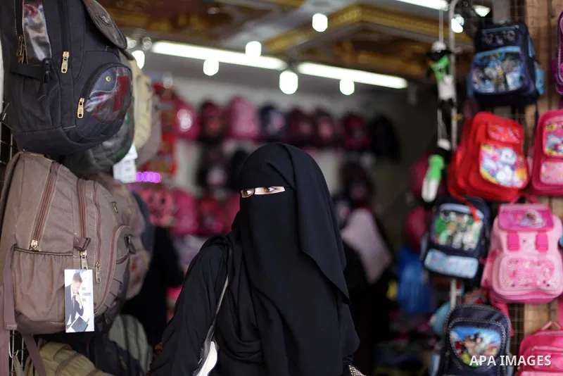 Palestinians shop during preperation for the new school year at a market in Gaza City on Aug 21, 2013. Palestinian Ministry of Education announced the 25 August is the first day of new school year in the West Bank and Ga...
