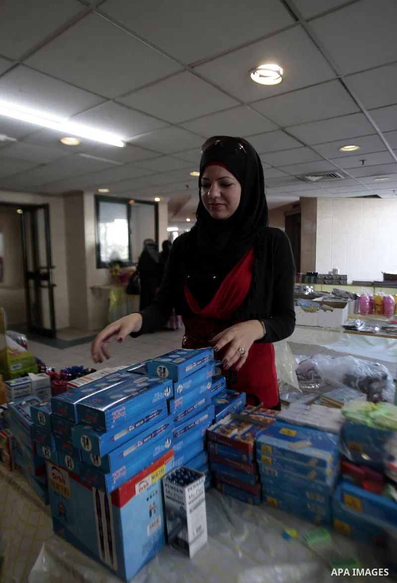 Palestinians shop during preperation for the new school year in the West Bank City of Nablus on Aug 22, 2013. Palestinian Ministry of Education announced the 25 August is the first day of new school year in the West Bank...