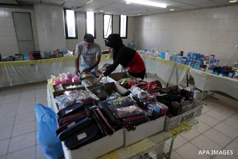 Palestinians shop during preperation for the new school year in the West Bank City of Nablus on Aug 22, 2013. Palestinian Ministry of Education announced the 25 August is the first day of new school year in the West Bank...