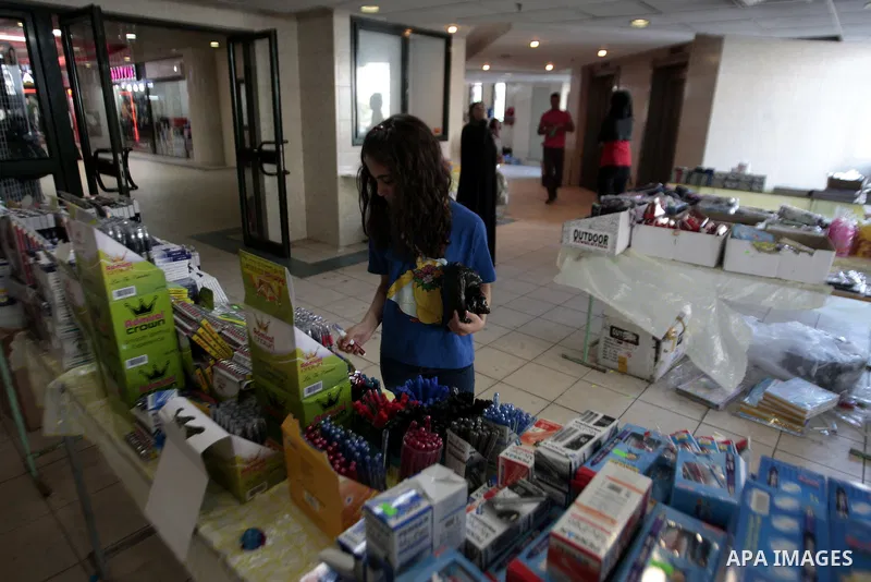 Palestinians shop during preperation for the new school year in the West Bank City of Nablus on Aug 22, 2013. Palestinian Ministry of Education announced the 25 August is the first day of new school year in the West Bank...