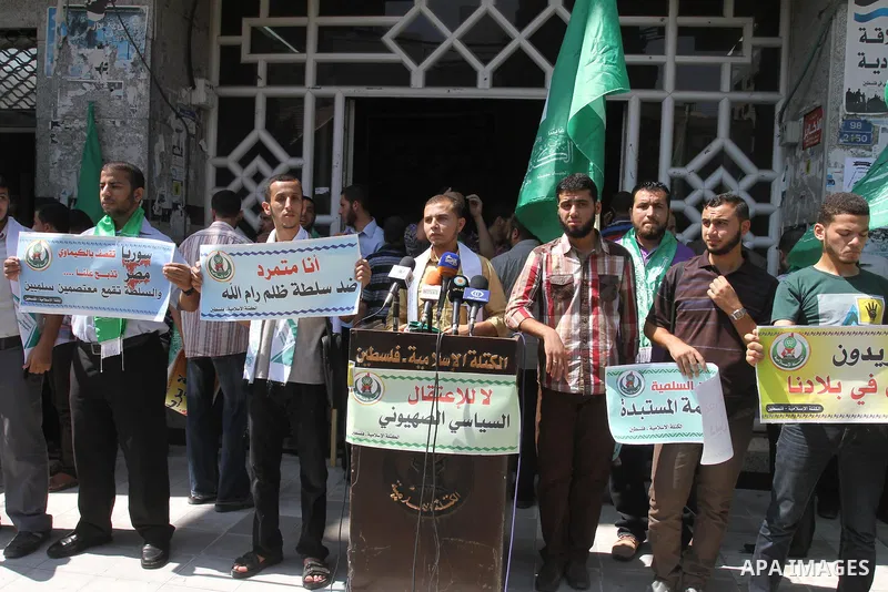 Palestinians hold banners during a protest calling for stop against members of Hamas violence by Ramallah government, in Gaza city on Aug. 22, 2013. Photo by Mohammed Asad