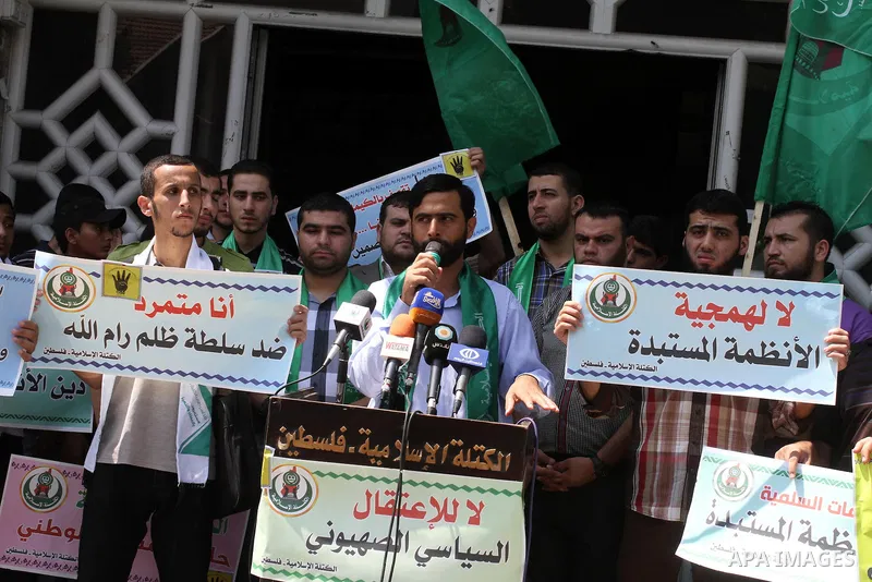 Palestinians hold banners during a protest calling for stop against members of Hamas violence by Ramallah government, in Gaza city on Aug. 22, 2013. Photo by Mohammed Asad