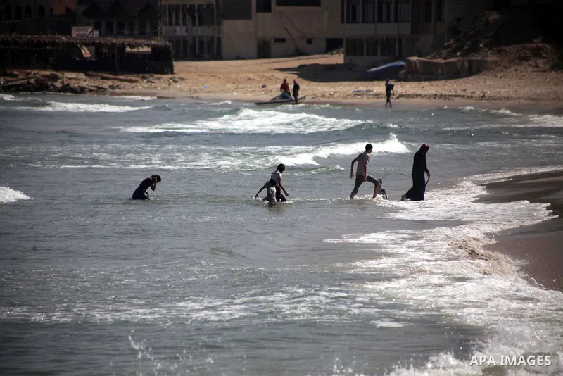 Palestinian fishermen work on their boats during a rally inside the port of Gaza to protest on the Israeli siege on the Gaza Strip and the five-year anniversary of the entry of first two ships solidarity with Gaza, in Ga...