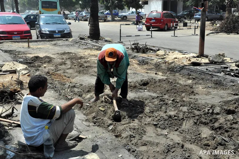 Egyptian workers repair the roads at the Square of Rabaa El Adawiya in Cairo on August 22, 2013. Mubarak may leave jail on Thursday by court order after a week of bloody turmoil in which Egypt's new army-backed rulers cr...