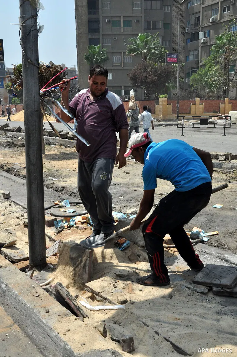 Egyptian workers repair the roads at the Square of Rabaa El Adawiya in Cairo on August 22, 2013. Mubarak may leave jail on Thursday by court order after a week of bloody turmoil in which Egypt's new army-backed rulers cr...