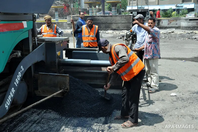 Egyptian workers repair the roads at the Square of Rabaa El Adawiya in Cairo on August 22, 2013. Mubarak may leave jail on Thursday by court order after a week of bloody turmoil in which Egypt's new army-backed rulers cr...