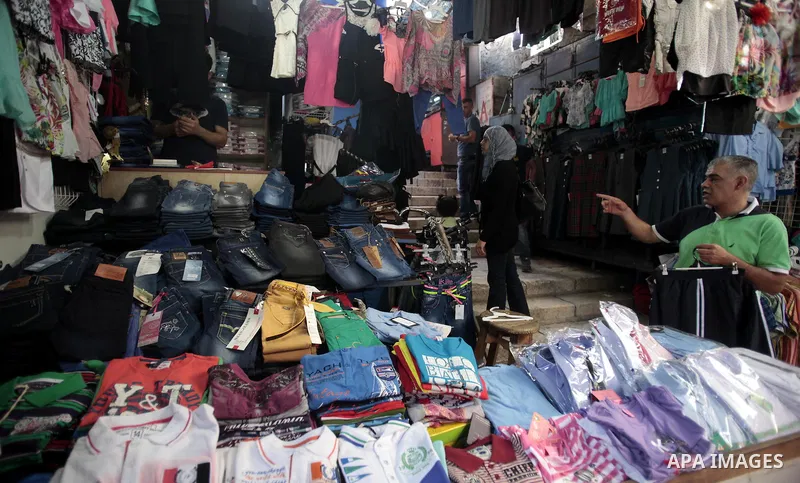 Palestinians shop during preperation for the new school year at a market in Jerusalem on Aug 22, 2013. Palestinian Ministry of Education announced the 25 August is the first day of new school year in the West Bank and Ga...