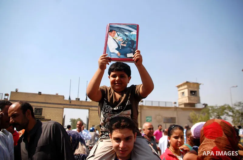 Supporters of Egypt's deposed autocrat Hosni Mubarak hold posters of him and chant slogans in front of Torah Prison, where Egypt's deposed autocrat Hosni Mubarak has been held, in Cairo, Egypt, Thursday, Aug. 22, 2013. E...