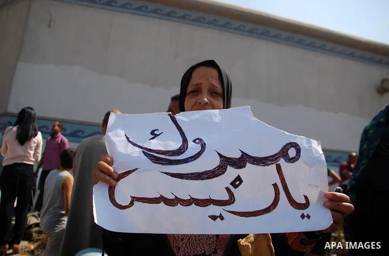 Supporters of Egypt's deposed autocrat Hosni Mubarak hold posters of him and chant slogans in front of Torah Prison, where Egypt's deposed autocrat Hosni Mubarak has been held, in Cairo, Egypt, Thursday, Aug. 22, 2013. E...