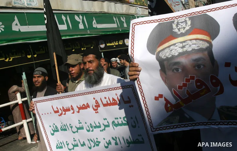 Palestinian Salafists shout slogans during a rally in protest of what they say are recent massacres committed against Syrian and Egyptian people and against Syria's President Bashar al-Assad and Egypt's army chief Genera...