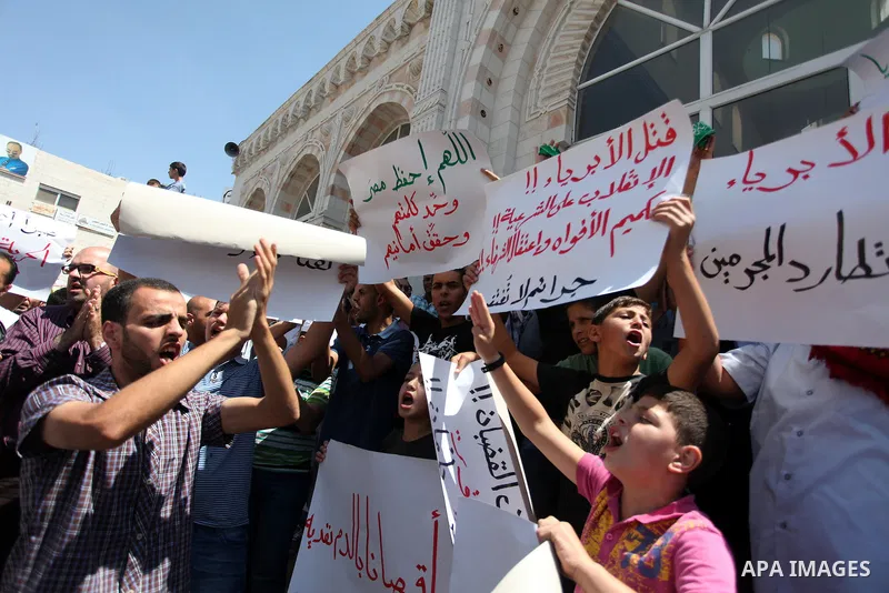 Palestinians raise their hands and four fingers, a sign that protesters say symbolizes the Rabaah al-Adawiya mosque in Cairo that was cleared last week by Egyptian security forces, during a rally in support of the ousted...
