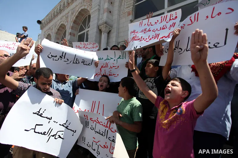 Palestinians raise their hands and four fingers, a sign that protesters say symbolizes the Rabaah al-Adawiya mosque in Cairo that was cleared last week by Egyptian security forces, during a rally in support of the ousted...
