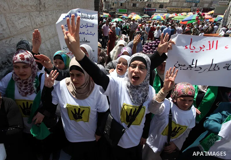 Palestinian girls raise their hands and four fingers, a sign that protesters say symbolizes the Rabaah al-Adawiya mosque in Cairo that was cleared last week by Egyptian security forces, during a rally in support of the o...