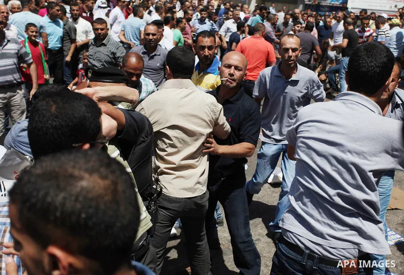 Palestinian protesters clash with plainclothes Palestinian Authority security during a rally in support of the ousted Egypt's President Mohamed Morsi organized by Hamas movement in the West Bank city of Ramallah, Friday,...