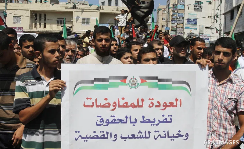 Palestinian supporters of Hamas and Islamic Jehad hold a placard during a protest against Palestinian-Israeli negotiations on August 23, 2013, in Gaza City. A senior Palestinian official accused on August 23 Israel of pr...