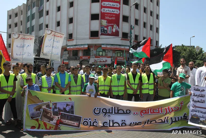 Palestinian supporters of Hamas and Islamic Jehad hold national flags during a protest against Palestinian-Israeli negotiations on August 23, 2013, in Gaza City. A senior Palestinian official accused on August 23 Israel...