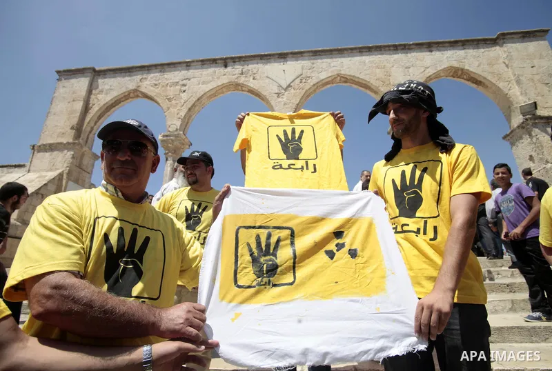 Palestinian supporters of the radical Islamist movement Hamas raise their hands and four fingers, a sign that protesters say symbolizes the Rabaah al-Adawiya mosque in Cairo that was cleared last week by Egyptian securit...