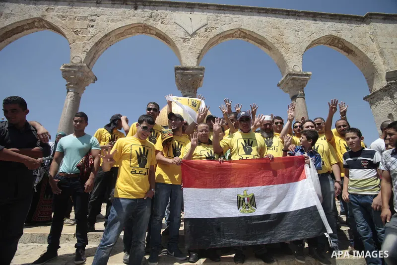 Palestinian supporters of the radical Islamist movement Hamas raise their hands and four fingers, a sign that protesters say symbolizes the Rabaah al-Adawiya mosque in Cairo that was cleared last week by Egyptian securit...