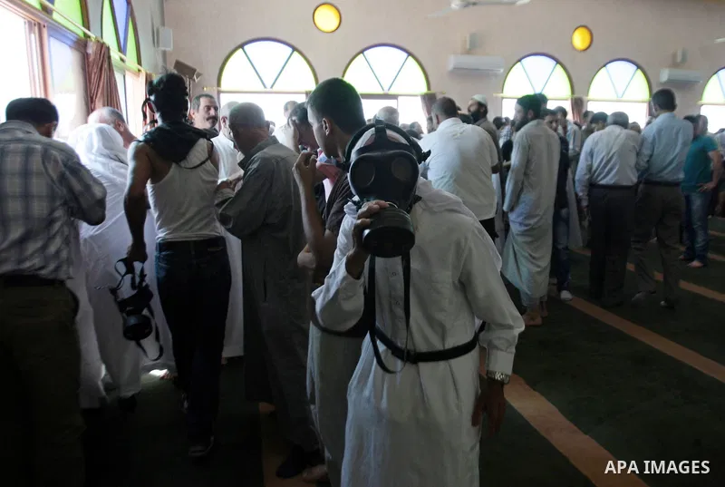 Palestinian worshipers cover their faces after inhaling tear gas fired by Israeli security forces at a mosque during Friday prayer in the village of Kfar Qaddum, near Nablus in the occupied West Bank on August 13, 2013....