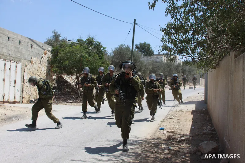 Israeli security forces run after Palestinian protesters during clashes following a protest against the expropriation of Palestinian land by Israel in the village of Kfar Qaddum, near Nablus in the occupied West Bank on...