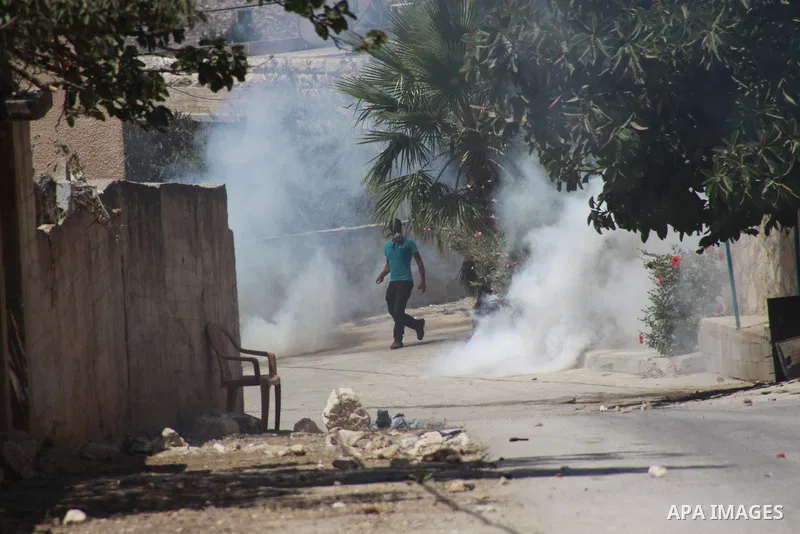 A Palestinian protester throws stones at Israeli security forces during clashes following a protest against the expropriation of Palestinian land by Israel in the village of Kfar Qaddum, near Nablus in the occupied West...