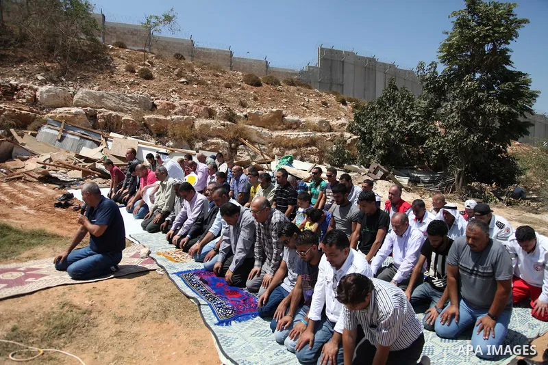 Palestinian from Ka'abneh Arabs attend Friday prayers in protest against evacuating them by Israeli bulldozers, in Bir Nabala near Jerusalem, Aug 23, 2013. Israeli authorities evacuated 53 Bedouin from residents of the c...