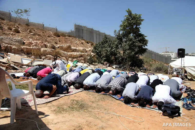 Palestinian from Ka'abneh Arabs attend Friday prayers in protest against evacuating them by Israeli bulldozers, in Bir Nabala near Jerusalem, Aug 23, 2013. Israeli authorities evacuated 53 Bedouin from residents of the c...