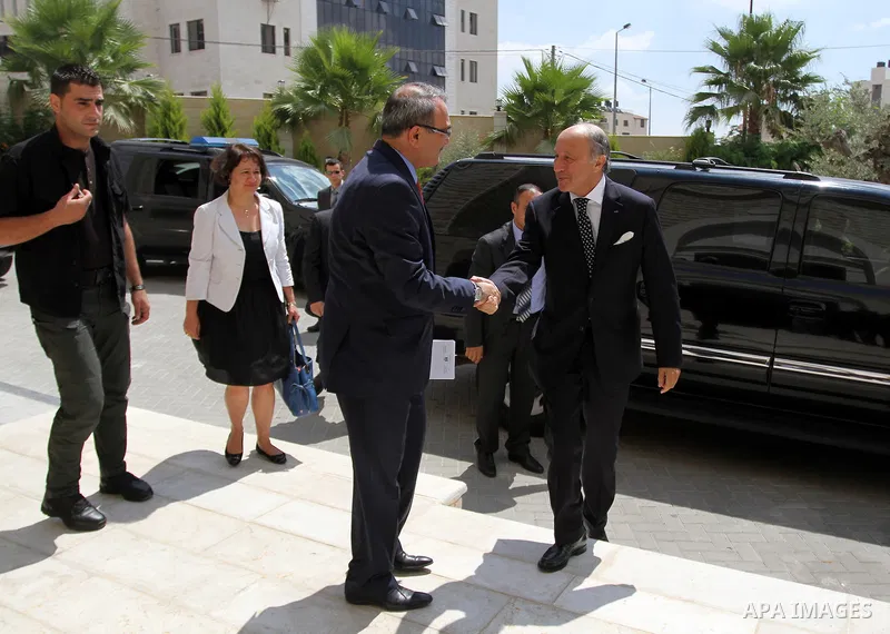 French Foreign Minister Laurent Fabius (R) is welcomed as he arrives for a meeting with Palestinian Prime Minister on August 24, 2013 in the West Bank city of Ramallah. Fabius visits Israel and the Palestinian territorie...