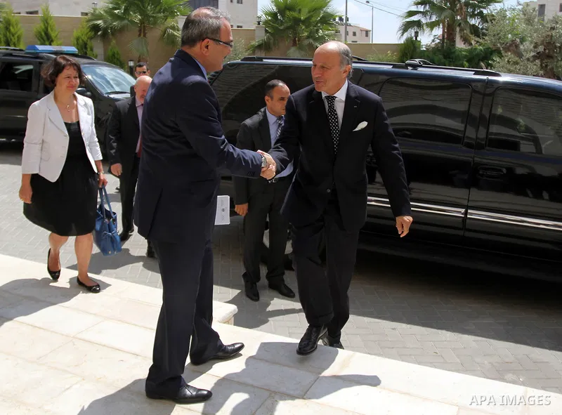 French Foreign Minister Laurent Fabius (R) is welcomed as he arrives for a meeting with Palestinian Prime Minister on August 24, 2013 in the West Bank city of Ramallah. Fabius visits Israel and the Palestinian territorie...