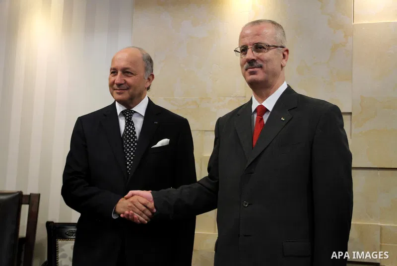 French Foreign Minister Laurent Fabius meets with Palestinian Prime Minister Rami Hamdallah (R) on August 24, 2013 in the West Bank city of Ramallah. Fabius visits Israel and the Palestinian territories this weekend to e...