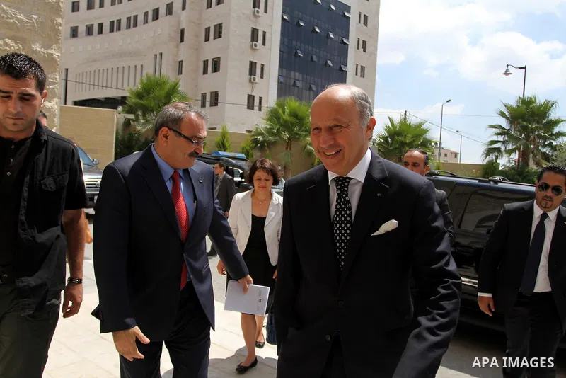 French Foreign Minister Laurent Fabius (R) is welcomed as he arrives for a meeting with Palestinian Prime Minister on August 24, 2013 in the West Bank city of Ramallah. Fabius visits Israel and the Palestinian territorie...