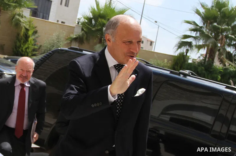 French Foreign Minister Laurent Fabius (R) is welcomed as he arrives for a meeting with Palestinian Prime Minister on August 24, 2013 in the West Bank city of Ramallah. Fabius visits Israel and the Palestinian territorie...