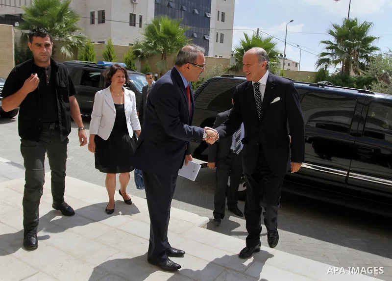 French Foreign Minister Laurent Fabius (R) is welcomed as he arrives for a meeting with Palestinian Prime Minister on August 24, 2013 in the West Bank city of Ramallah. Fabius visits Israel and the Palestinian territorie...