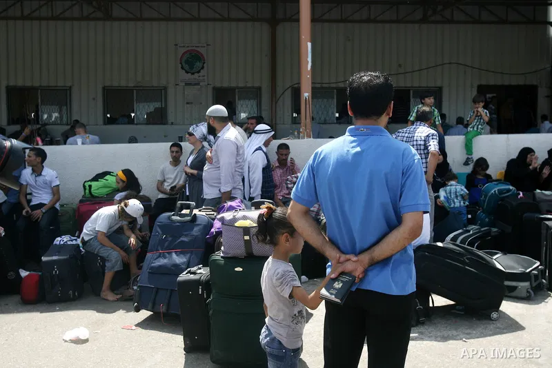 Palestinians wait to cross into Egypt at Rafah crossing between Egypt and southern Gaza Strip August 24, 2013. Egypt reopened its border crossing with the Gaza Strip on Saturday after four days of closure, allowing stran...