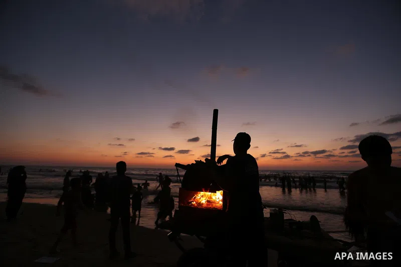 Palestinians enjoy sitting on the sea at Gaza beach during Friday holiday in Gaza city, Aug. 23, 2013. Gazans escape to the beach and out from their homes during heat wave and power outages. Photo by Mahmoud Hamda