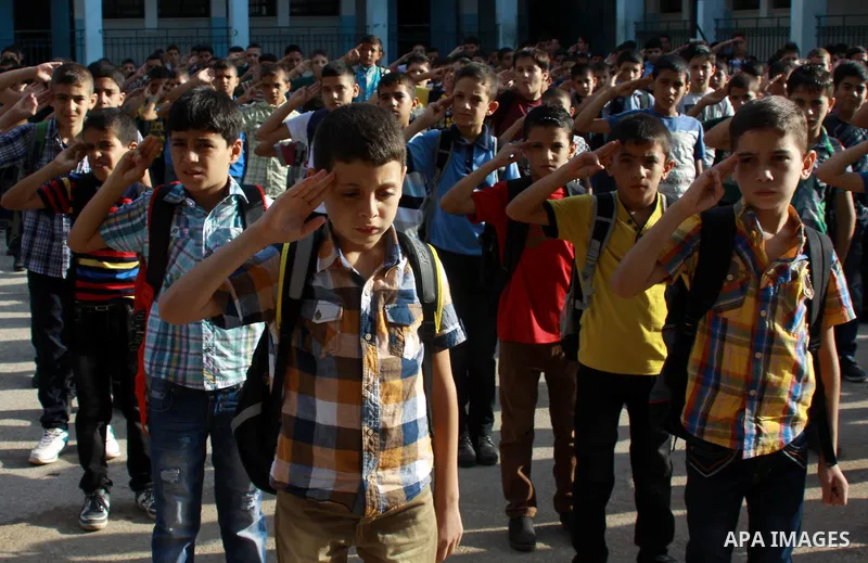 Palestinian students return back to their school in the morning of the first day of the new year study in the West Bank city of Nablus, on Aug. 25, 2013. Photo by Nedal Eshtayah