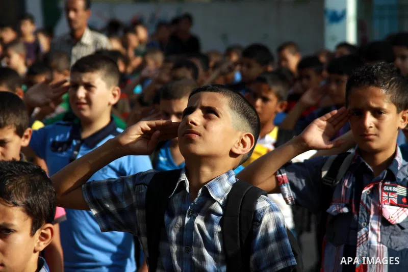 Palestinian students return back to their school in the morning of the first day of the new year study in the West Bank city of Nablus, on Aug. 25, 2013. Photo by Nedal Eshtayah