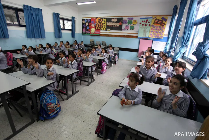 Palestinian students return back to their school in the morning of the first day of the new year study in the West Bank city of Ramallah, on Aug. 25, 2013. Photo by Issam Rimawi