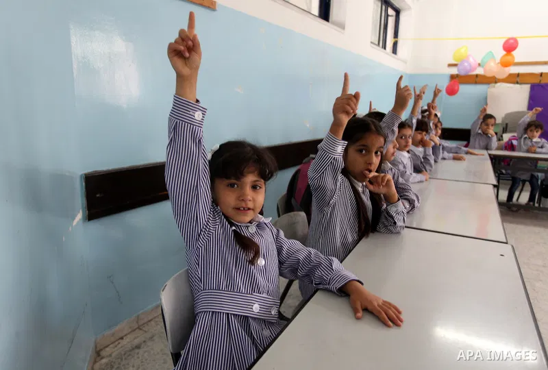Palestinian students return back to their school in the morning of the first day of the new year study in the West Bank city of Ramallah, on Aug. 25, 2013. Photo by Issam Rimawi