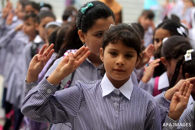 Palestinian students return back to their school in the morning of the first day of the new year study in the West Bank city of Ramallah, on Aug. 25, 2013. Photo by Issam Rimawi
