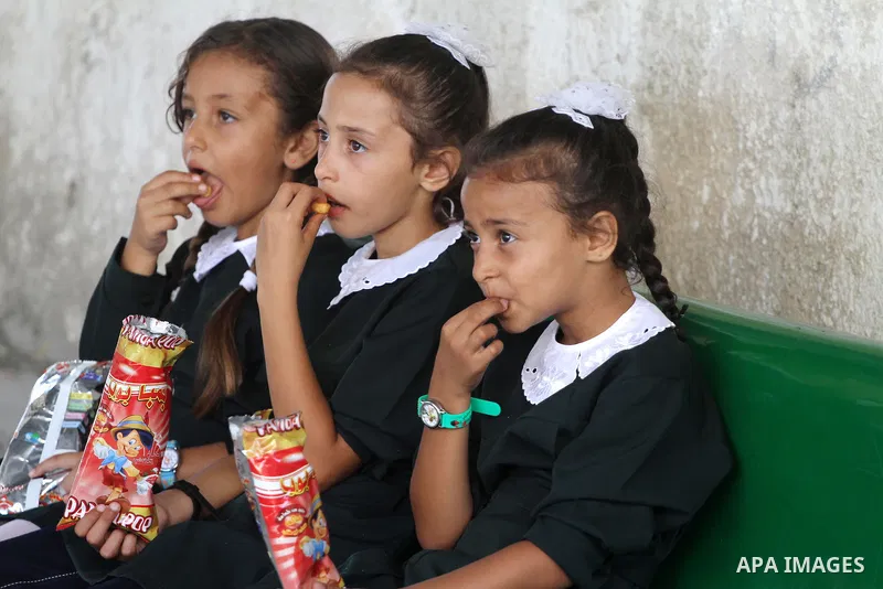 Palestinian students return back to their school in the morning of the first day of the new year study in Gaza city, on Aug. 25, 2013. Photo by Mohammed Asad