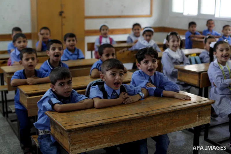 Palestinian schoolchildren attend a class at a U.N.-run school in Dir al-Balah in the central Gaza Strip, on the first day of the school year August 25, 2013. Photo by Ashraf Amra