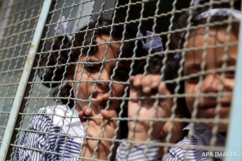 Palestinian school children attend a class at a U.N.-run school in Dir al-Balah in the central Gaza Strip, on the first day of the school year August 25, 2013. Photo by Ashraf Amra