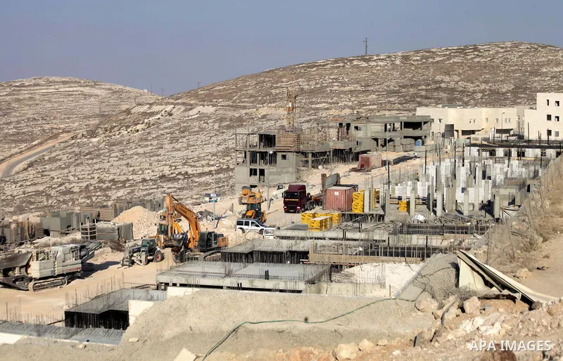 Laborers work at the construction site in Pisgat Zeev, an urban settlement in an area Israel annexed to Jerusalem after capturing it in the 1967 Middle East war, near the Arab village of Beit Hanina, August 25, 2013. Pal...
