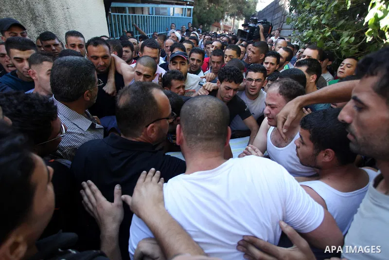 Relatives mourn the deaths of two Palestinians shot dead by Israeli troops, at a hospital in the West Bank city of Ramallah August 26, 2013. Israeli troops on Monday shot dead two Palestinians and wounded more than a doz...
