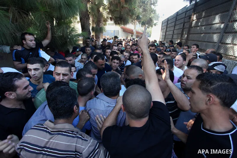 Relatives mourn the deaths of two Palestinians shot dead by Israeli troops, at a hospital in the West Bank city of Ramallah August 26, 2013. Israeli troops on Monday shot dead two Palestinians and wounded more than a doz...