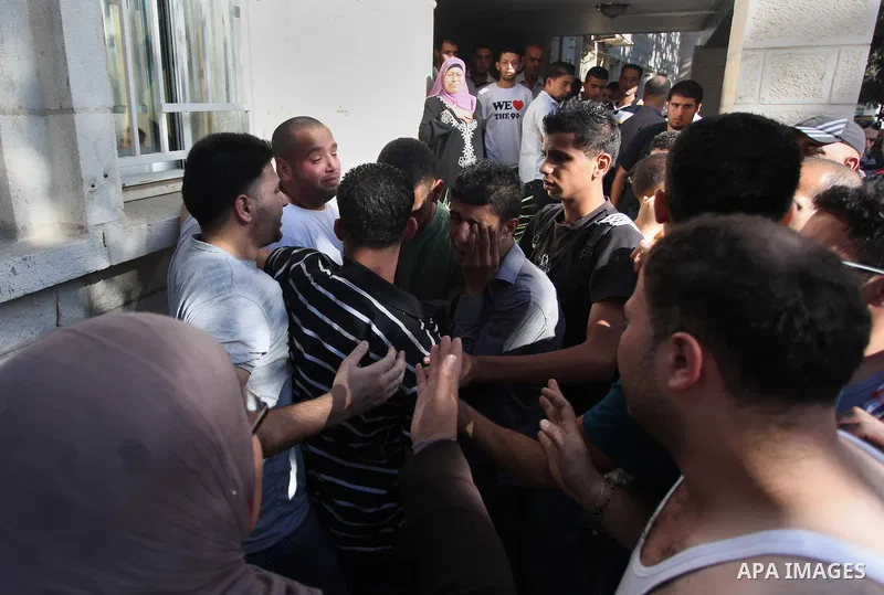 Relatives mourn the deaths of two Palestinians shot dead by Israeli troops, at a hospital in the West Bank city of Ramallah August 26, 2013. Israeli troops on Monday shot dead two Palestinians and wounded more than a doz...